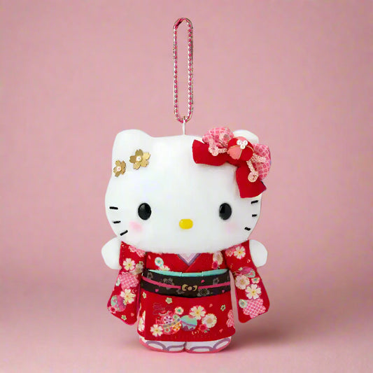 Plush keychain of a cat character in a red kimono with floral patterns on a white background
