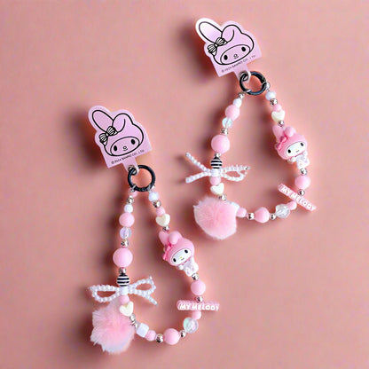 Pink beaded keychain with character design on a white surface
