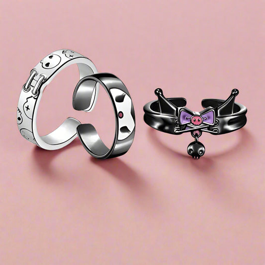 Two rings, one silver and one black with a bow design, on a white background with 'Kuromi' branding.