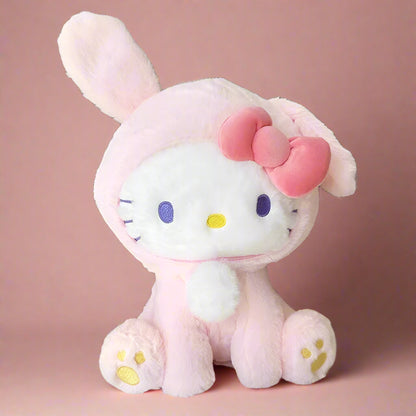 Two plushie toys, one in blue rabbit attire and the other in pink with a bow, resembling the Hello Kitty character.