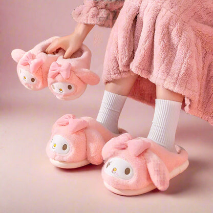 A pair of pink plush slippers designed to look like the character My Melody, with cute facial features and a bow.