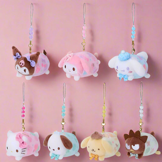 Set of small plush animal charms with decorative beads on a white background