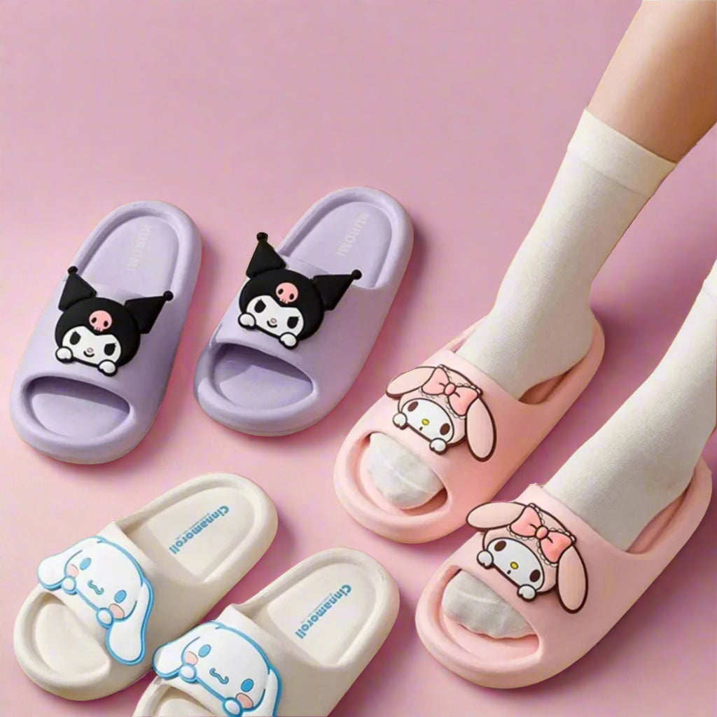 Kids' slippers with Sanrio characters, in pink, white, and purple colors, displayed on a floor.