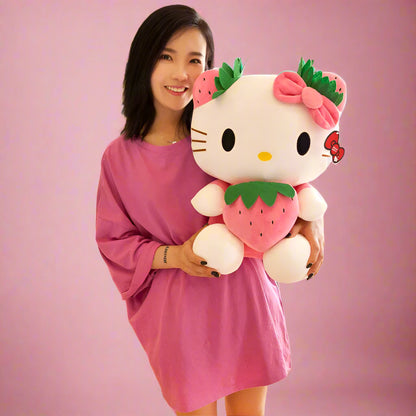 Woman holding a large Hello Kitty plush toy with strawberry design in a store setting.
