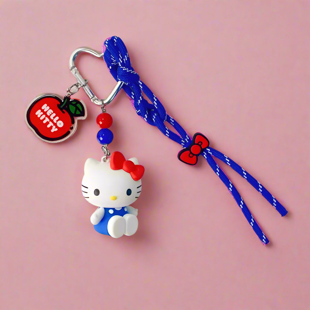Hello Kitty keychain with blue strap on a white background