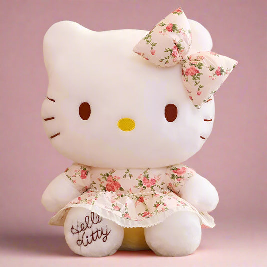 Two plushie toys resembling the character Hello Kitty, one standing upright and the other sitting, both white with floral patterned bows, placed next to a wicker basket.