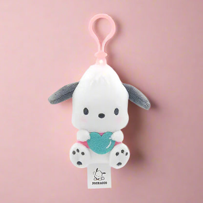 Two plush keychains featuring characters from Sanrio, one designed like a white cat with a blue heart and the other like a white bear with a red heart.