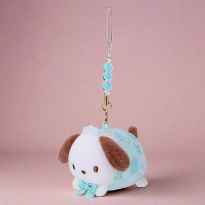 Plush dog charm with a blue bow on a white background