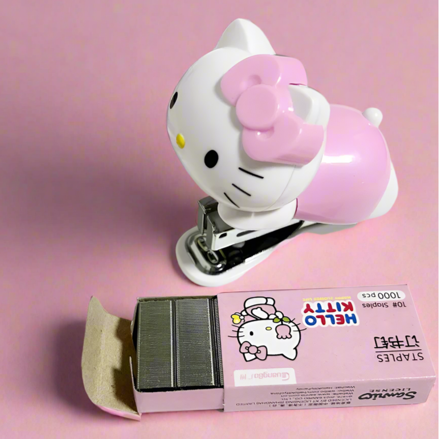 Hello Kitty-themed stapler with a box of staples on a white background