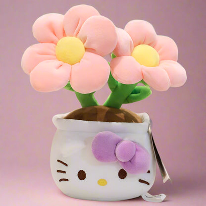 A plush flower bouquet with two flowers, one red and one pink, each with a Hello Kitty character design on the pot. The bouquet is displayed on a white grid surface.