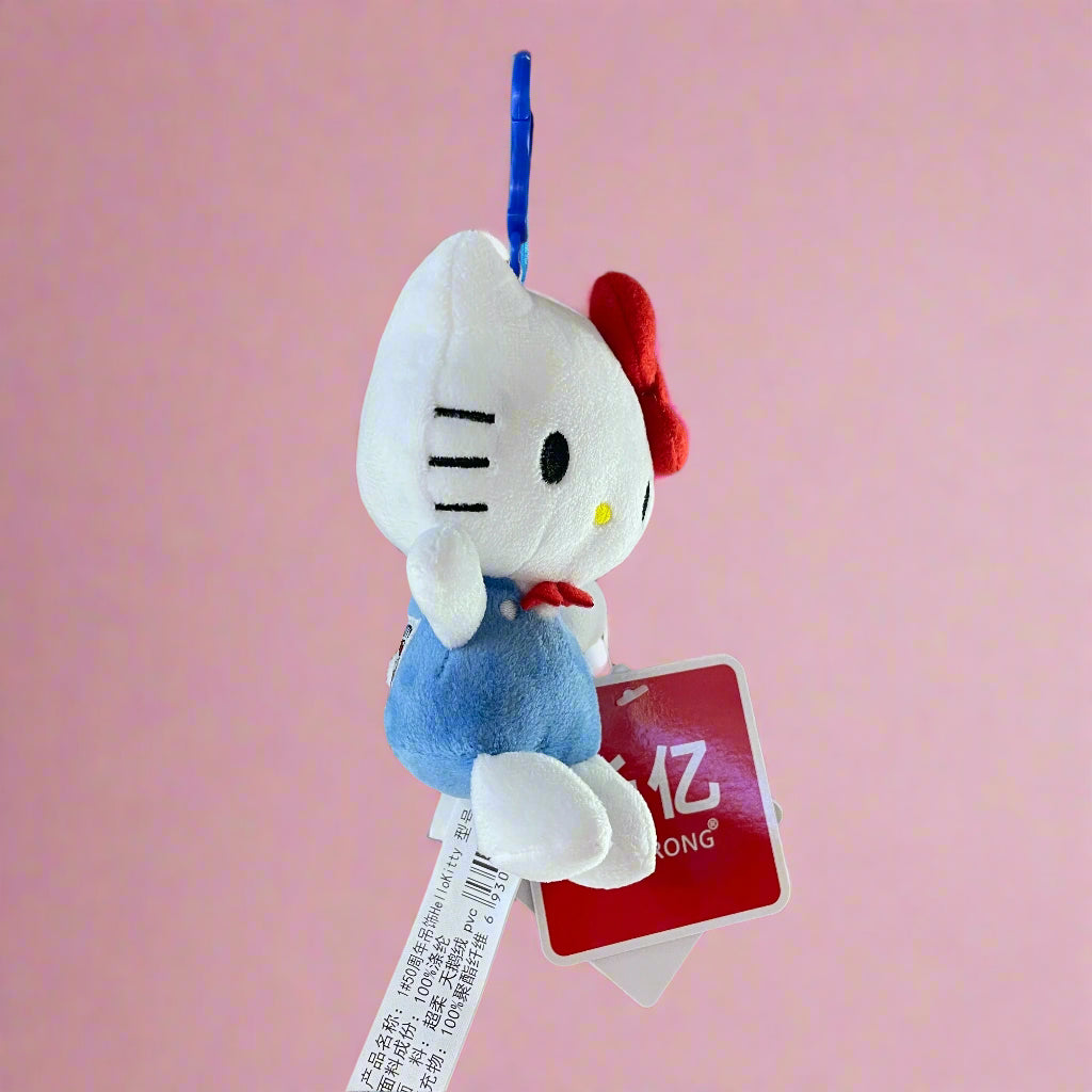 Plush keychain of a cartoon character with a red tag on a wooden surface