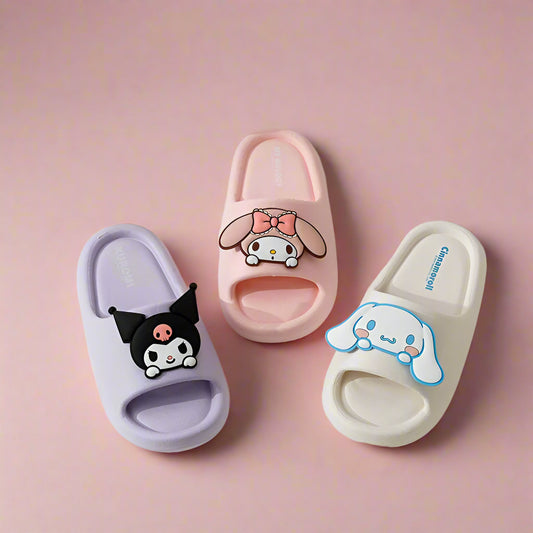 Three colorful slippers with cartoon characters on a white surface, next to a Starbucks cup.