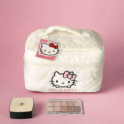 White Hello Kitty cosmetic bag with makeup items on a shelf