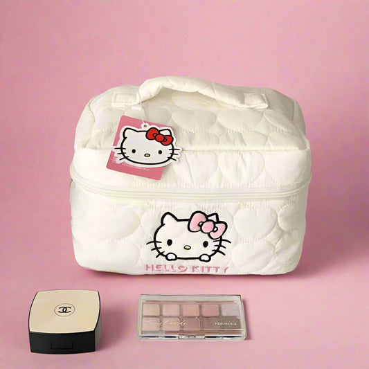White Hello Kitty cosmetic bag with makeup items on a shelf