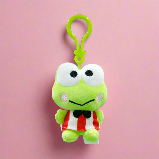 Plush frog toy with a clip on a green background