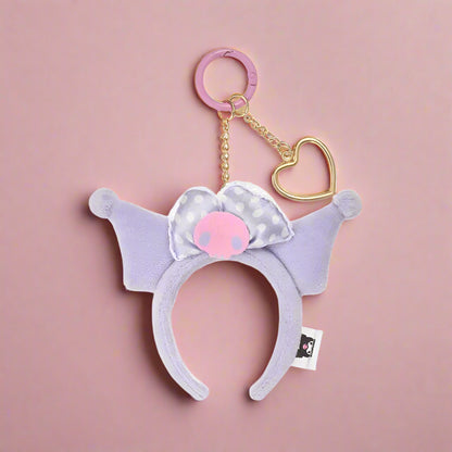 Plush headband with pink heart charm on a white background