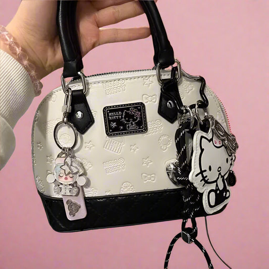 Handbag with Hello Kitty charms on a white background