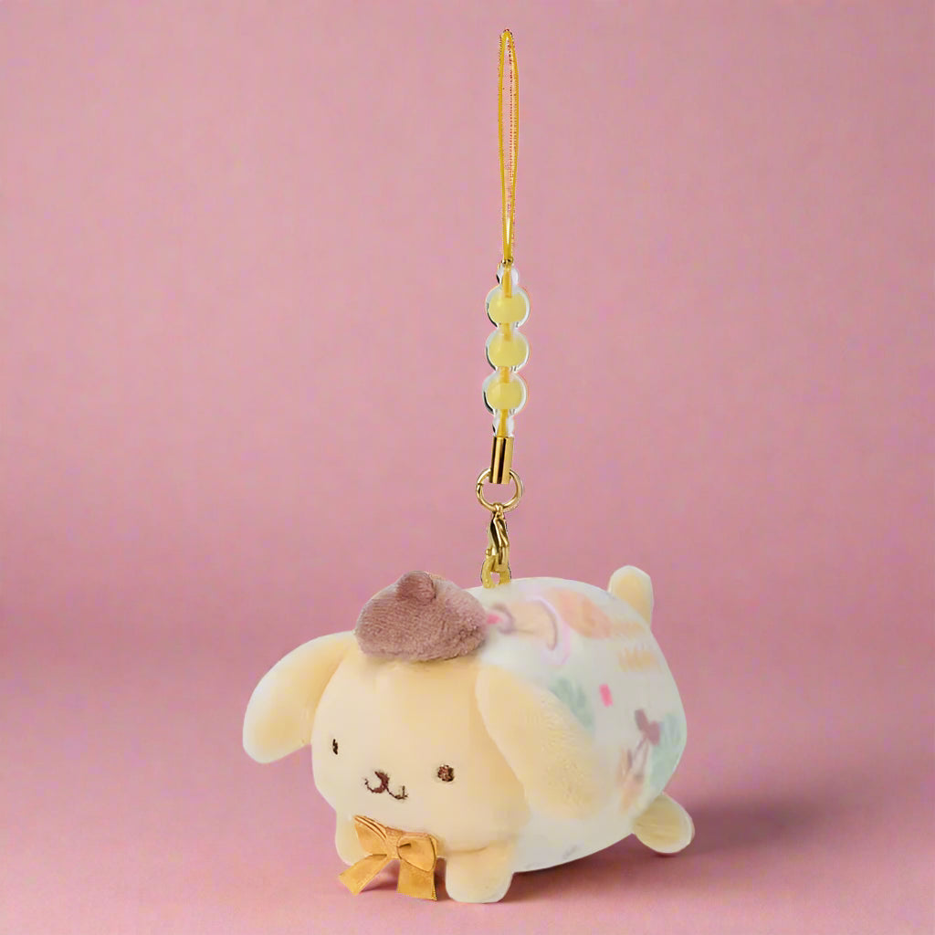 Plush charm of a cute animal with a hat and bow tie on a white background