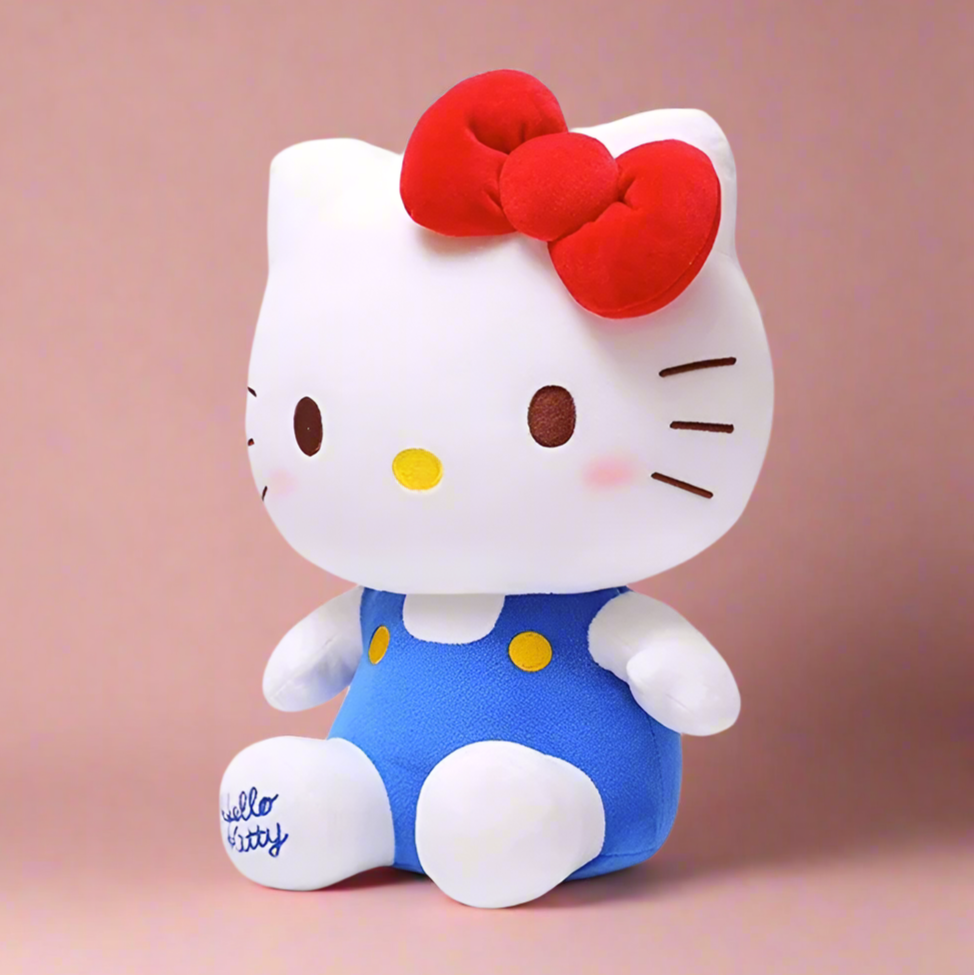 Plush toy resembling a character with a red bow and blue polka dot outfit on a white background, featuring the Sanrio logo.