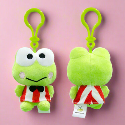 Two green plush frog keychains with a clip on a green background
