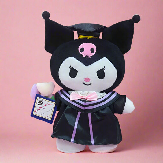 Four Sanrio character plushies dressed in graduation attire, with tags attached. One character is in a black outfit with a cat-like face, another is in a white outfit with a bear-like face, and two others are in pink outfits with a Hello Kitty-like design.