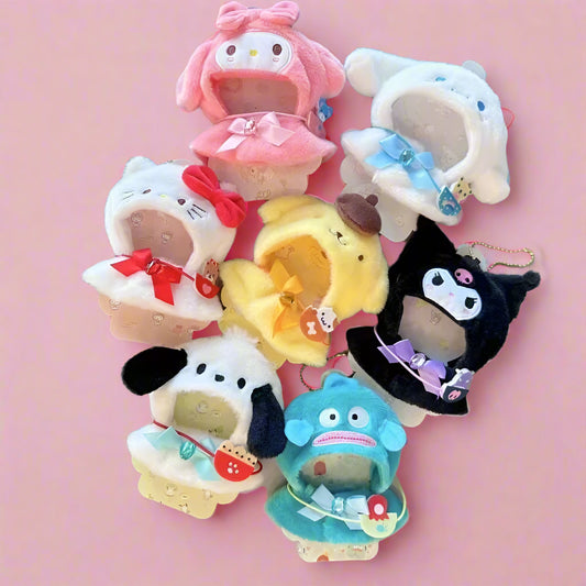 Set of colorful plush keychains with various designs on a light background.