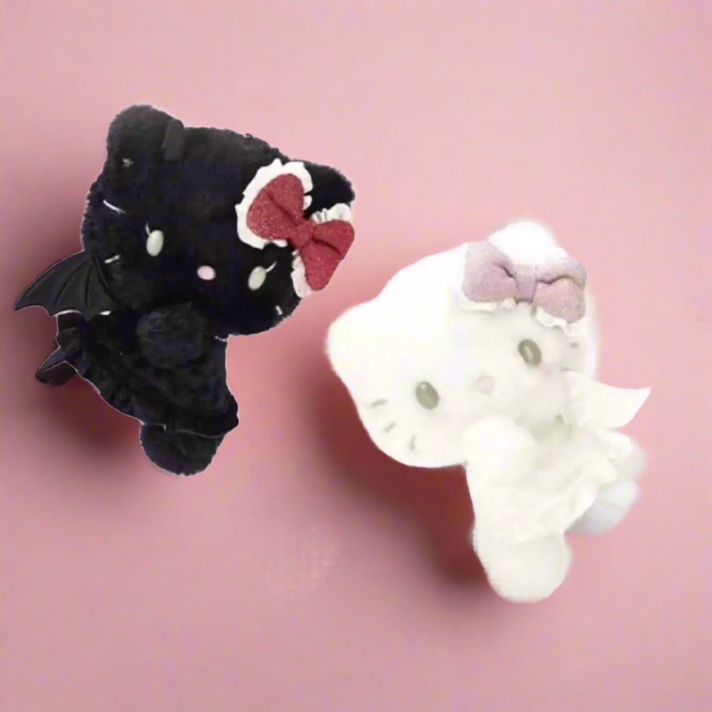 Two plush toys, one resembling a black cat with a red bow and the other a white cat with a pink bow, set against a pink background with heart decorations.